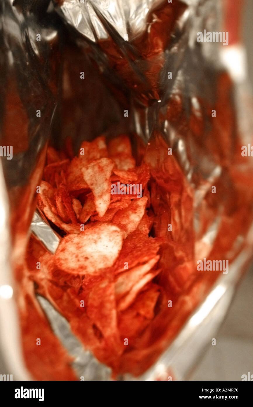 Looking down into a bag of ketchup potato chips. Stock Photo