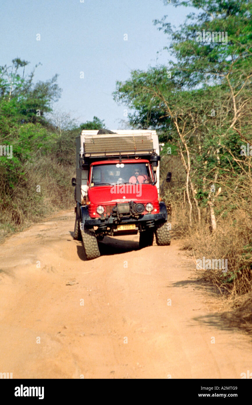 A Mercedes Benz Unimog overland truck negotiates a dirt road in Angola. Stock Photo