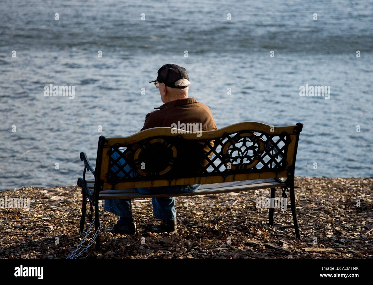 Elderly man sitting on a bench Stock Photo - Alamy