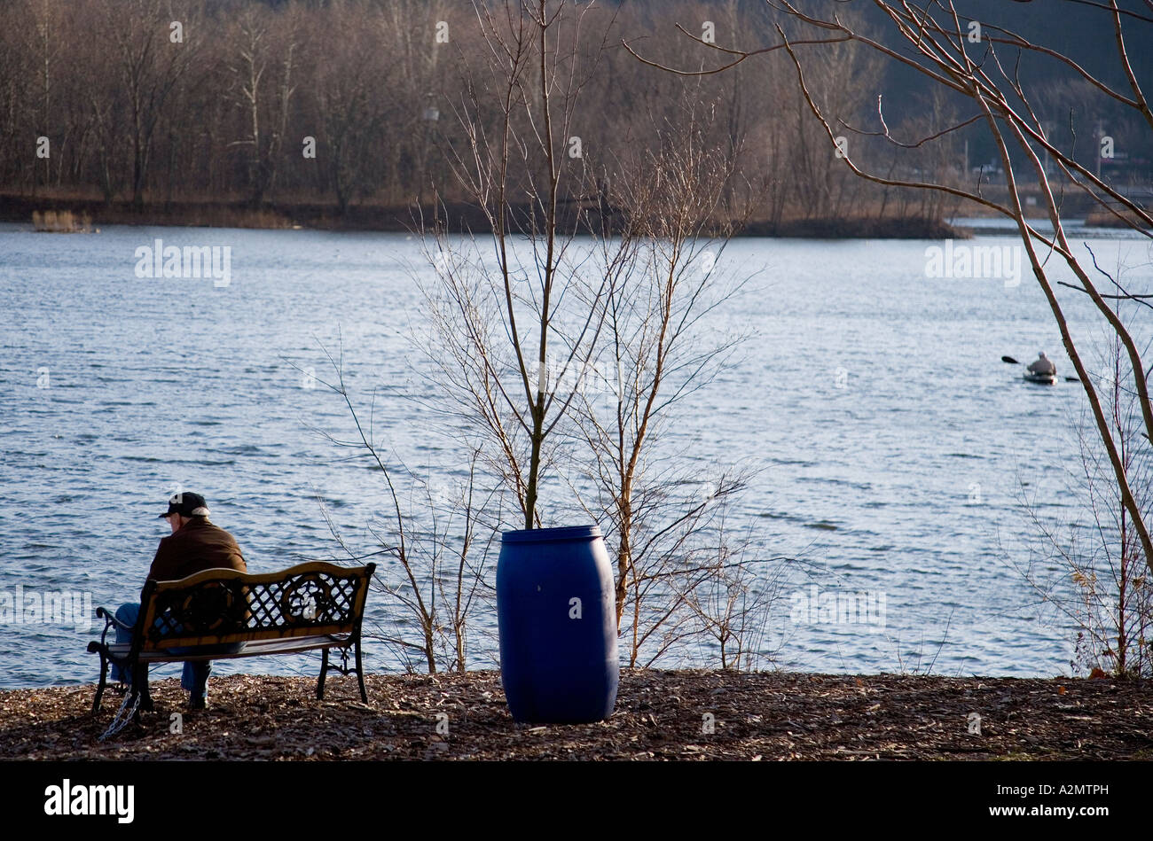 Elderly man sitting on a bench Stock Photo - Alamy