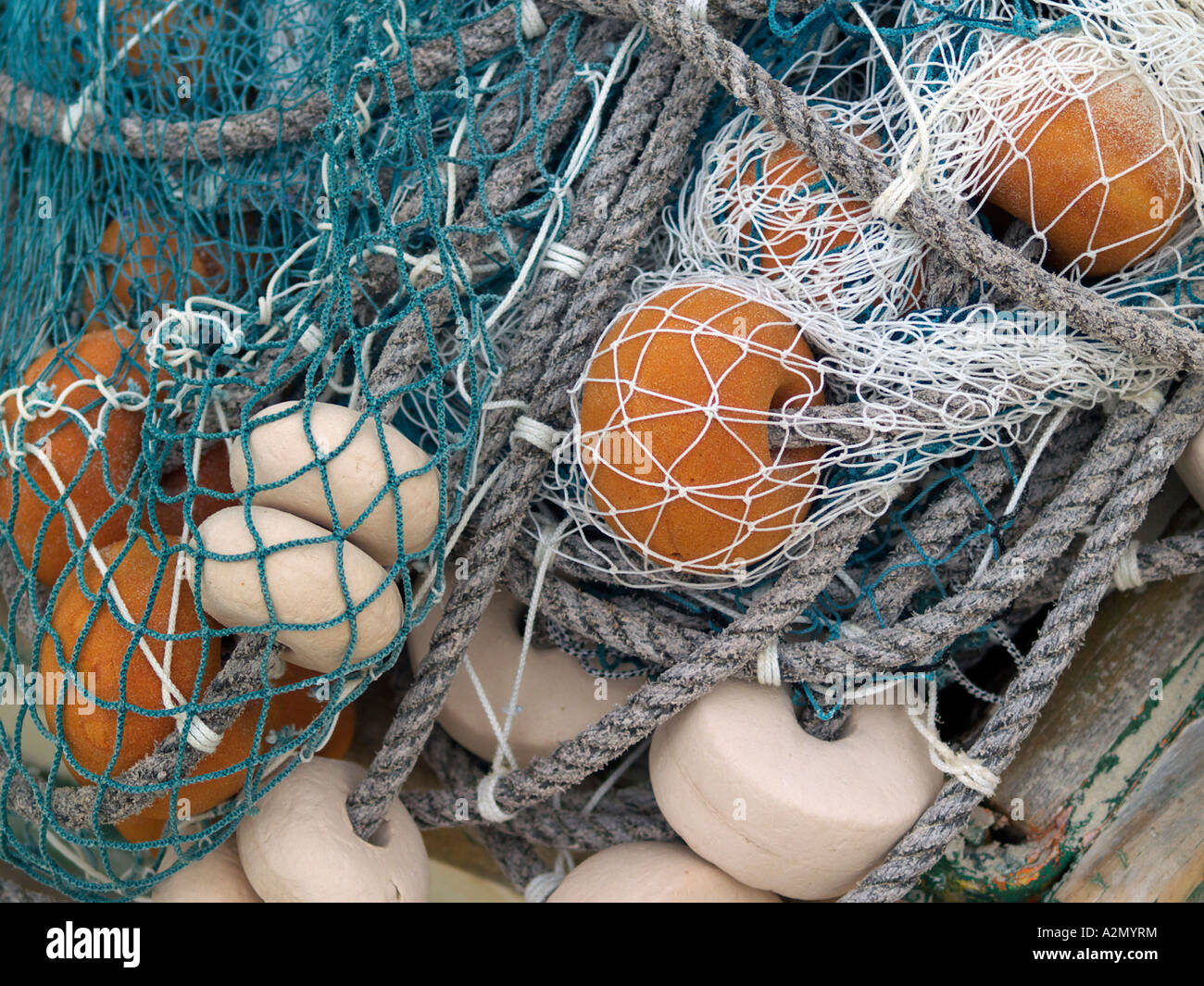 https://c8.alamy.com/comp/A2MYRM/tangled-blue-and-white-fishing-nets-with-ropes-and-floats-buoys-A2MYRM.jpg