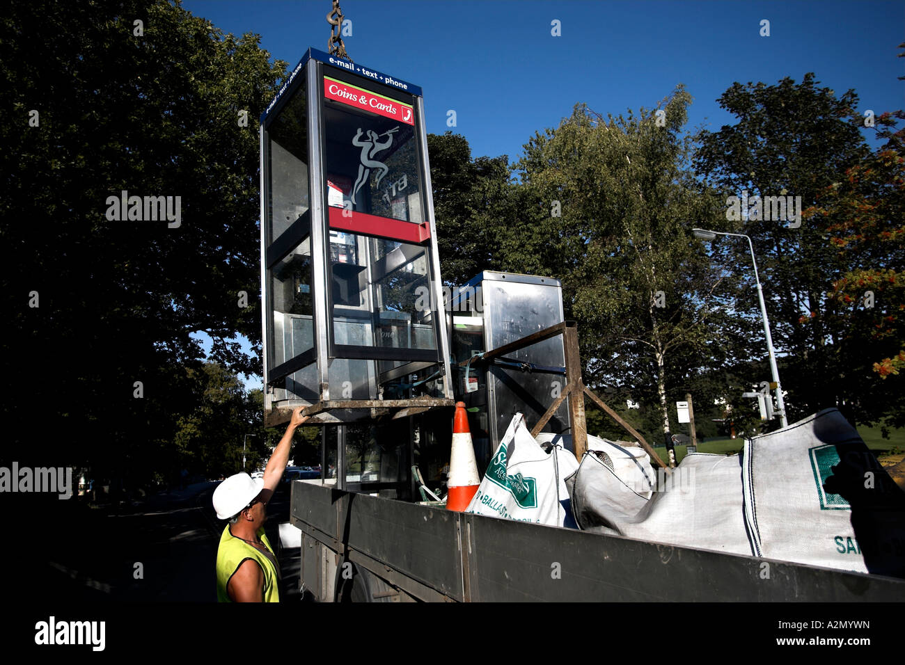 Removing Pay Phone Redundant due to Mobile /cell phone use Bownees on Windermere Cumbria UK Stock Photo