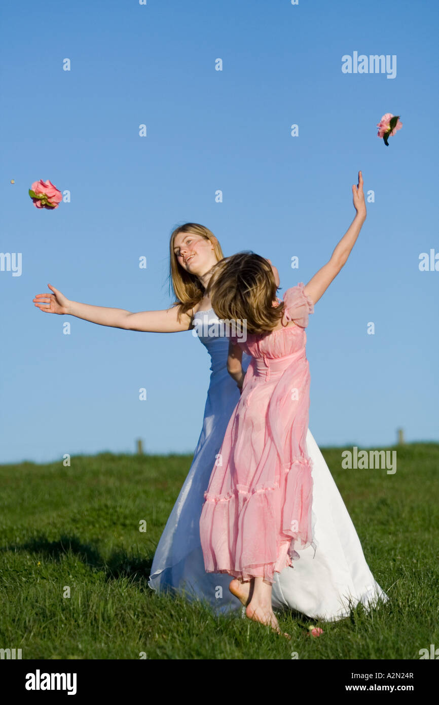 young girl woman female bride dancing in white pink wedding deb debutant dress on hill Stock Photo