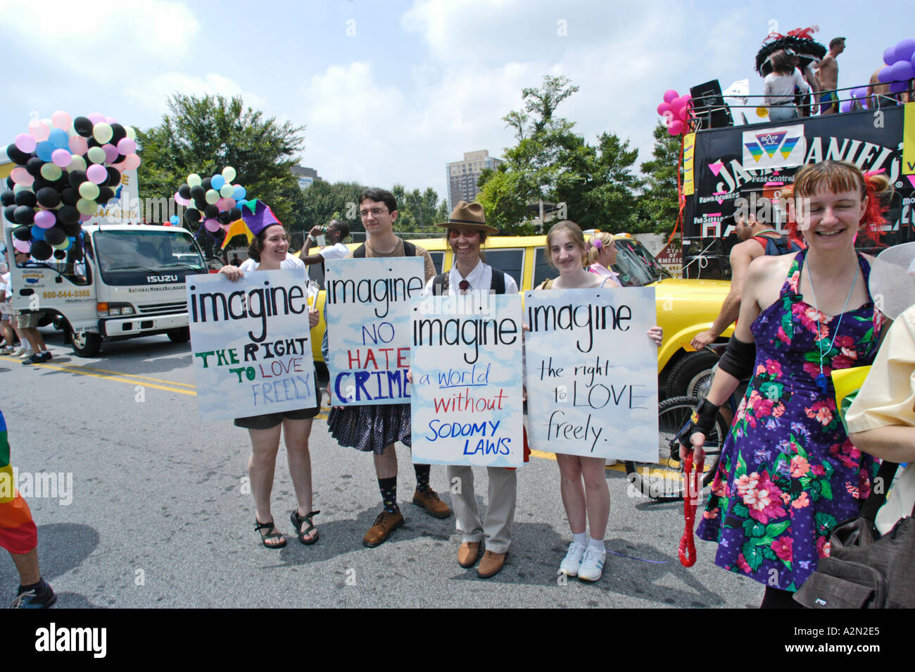women marchers No Hate Crimes Posters at real  Gay Rights and Pride parade on July 4th in Atlanta Georgia Stock Photo