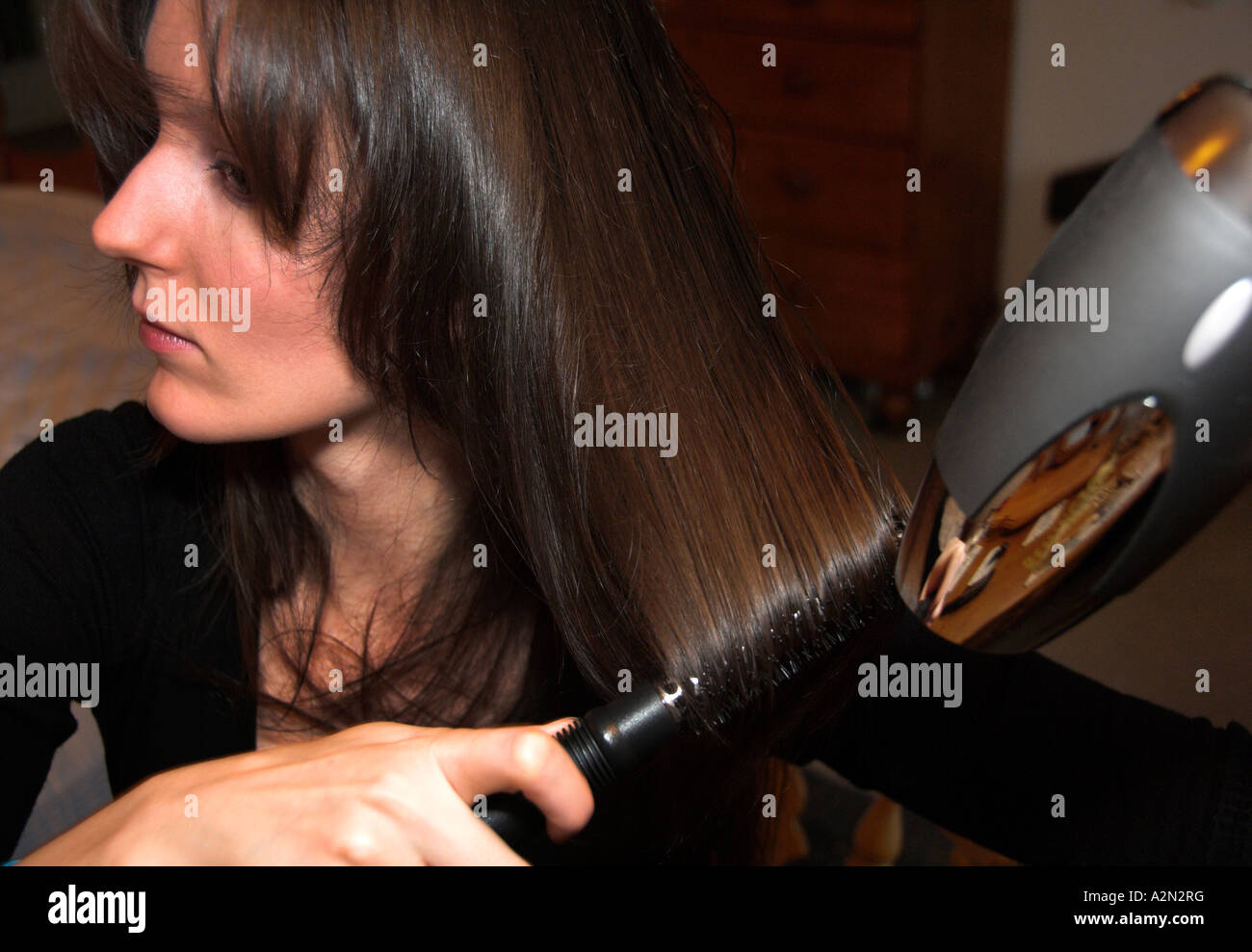 A young woman drying her hair Stock Photo