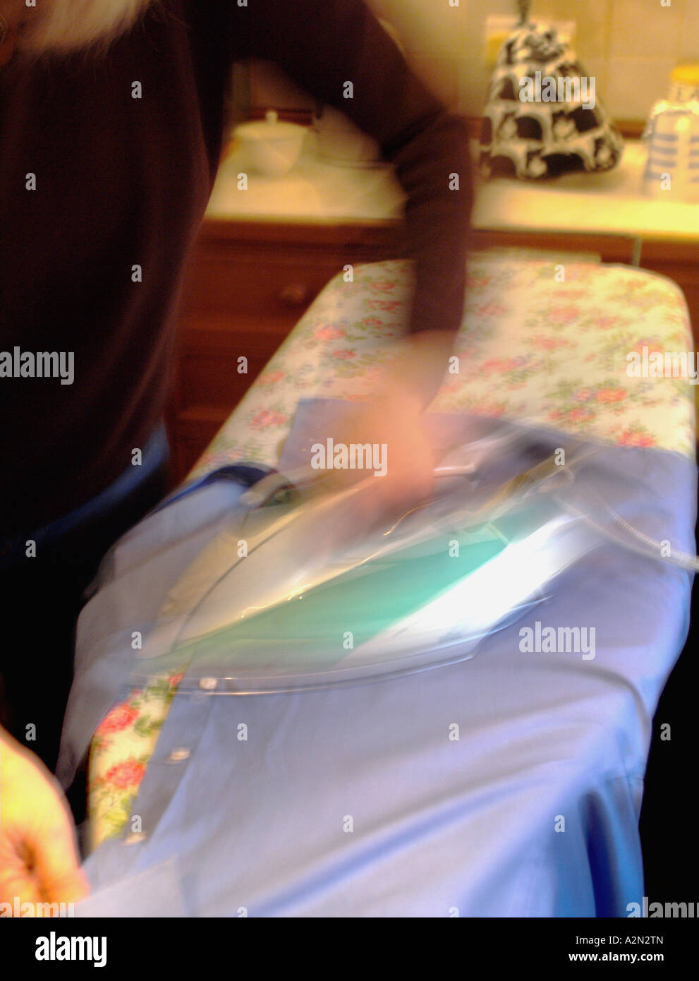 A woman ironing in the kitchen Stock Photo