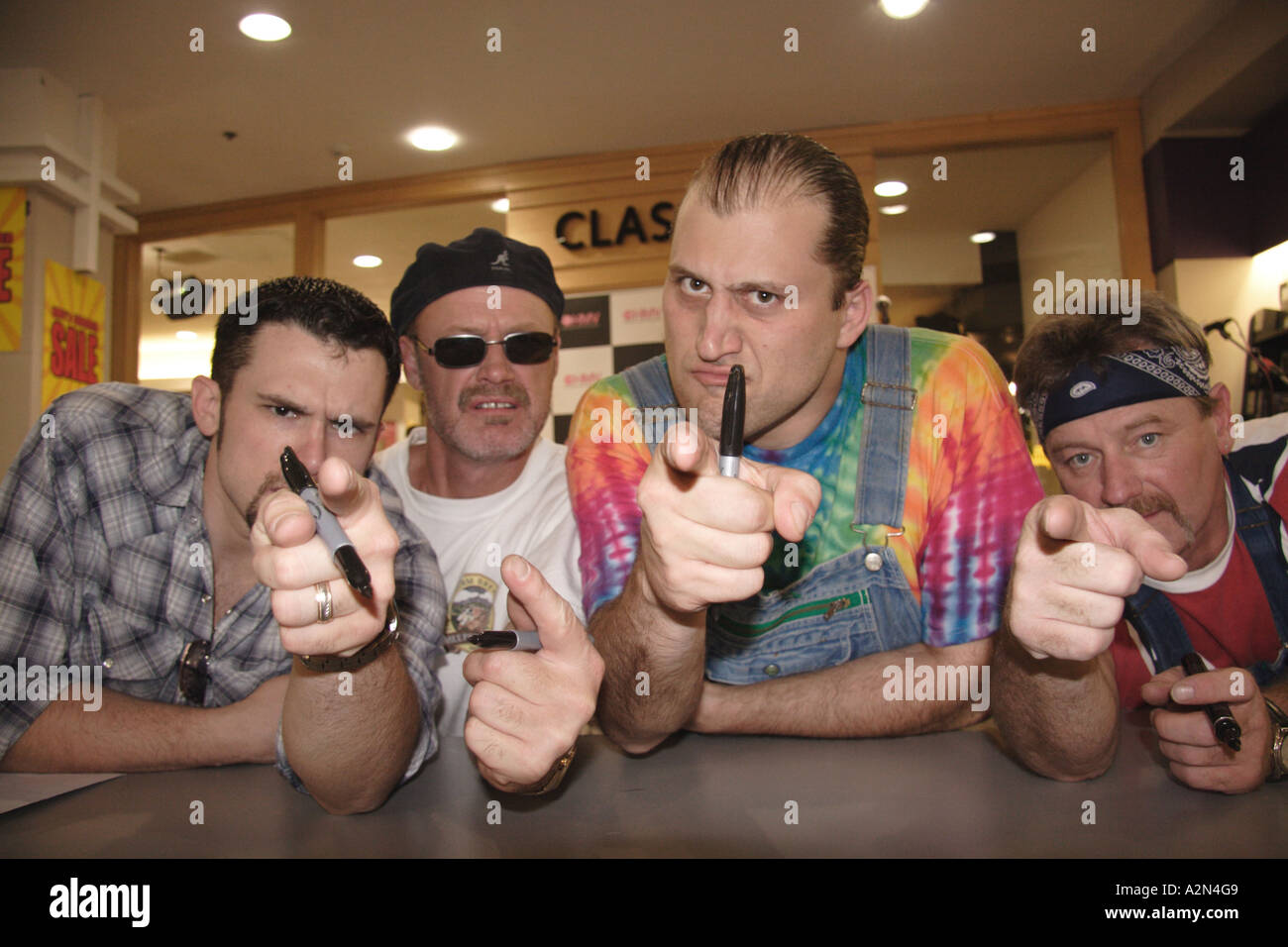 Members of Rockgrass band Hayseed Dixie sign autographs at HMV music store in London England Stock Photo