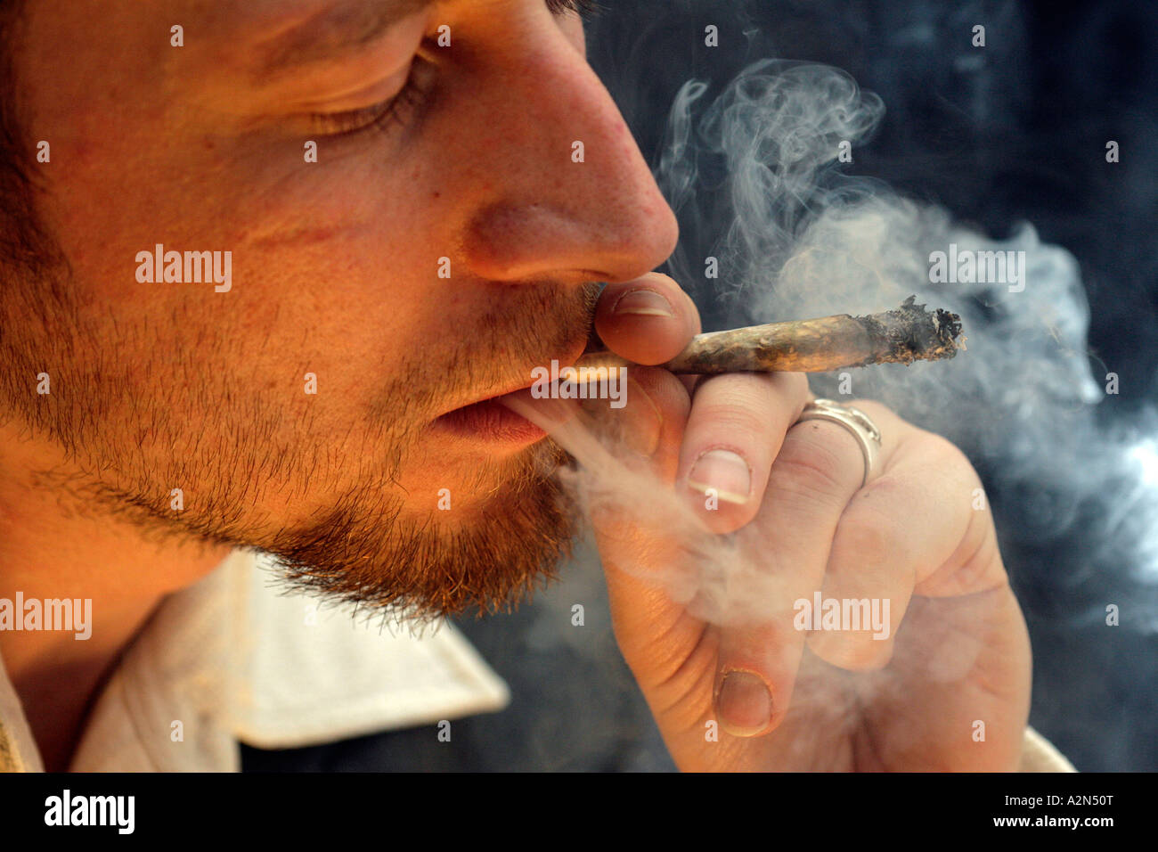 Close-up of young man smoking marijuana Stock Photo