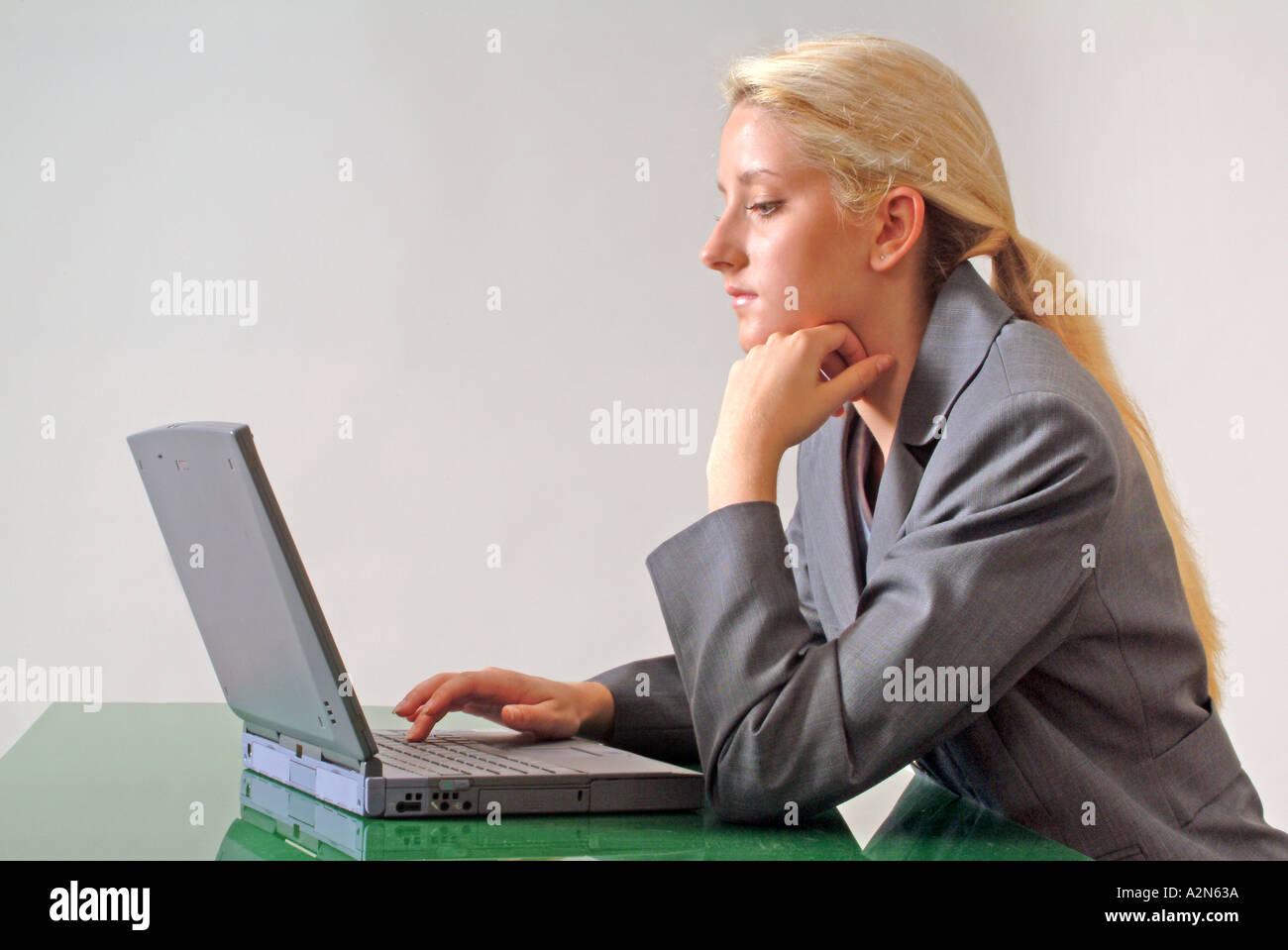 Woman in business suit on white background Stock Photo - Alamy
