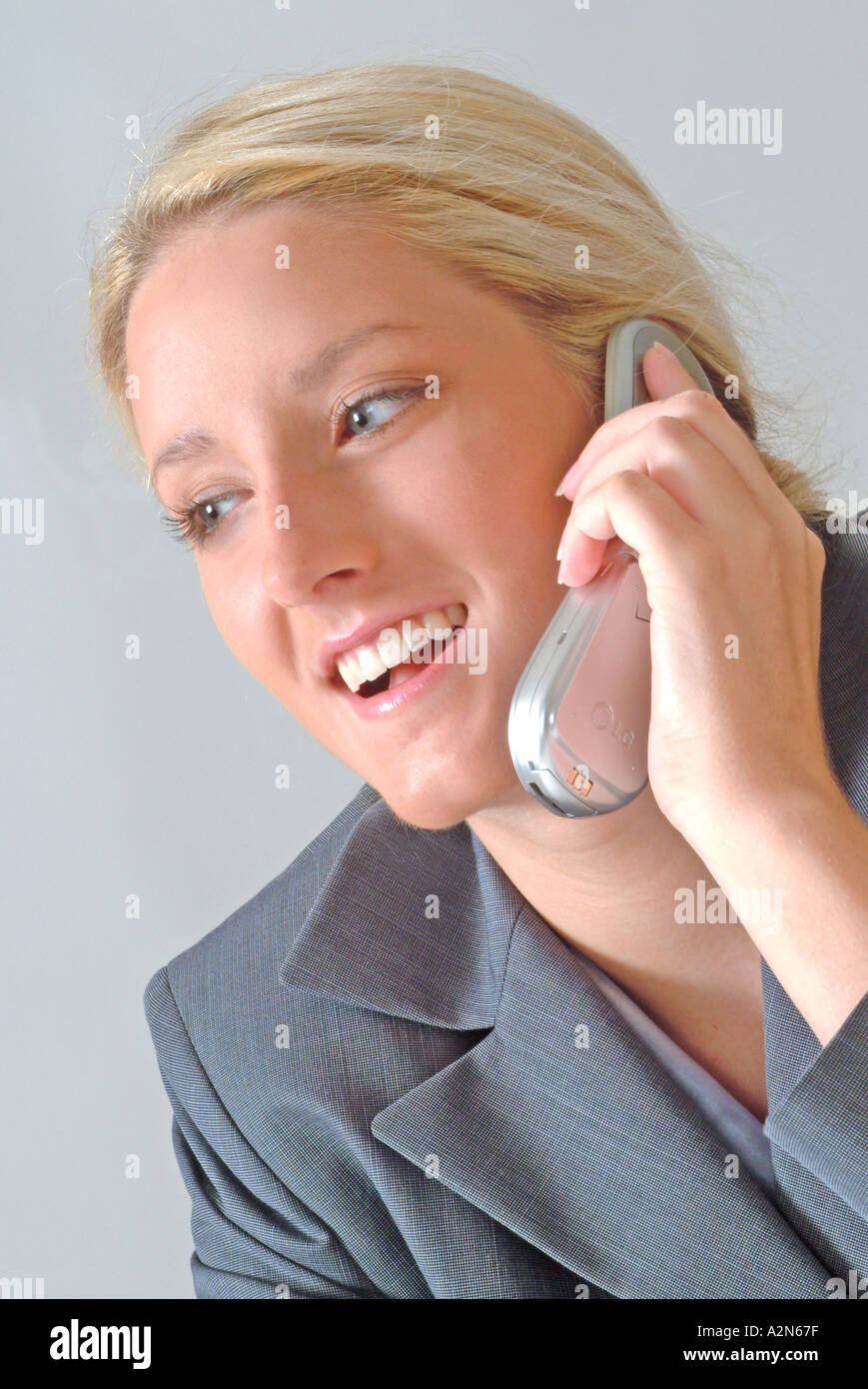 Woman in business suit talking on cell phone Stock Photo