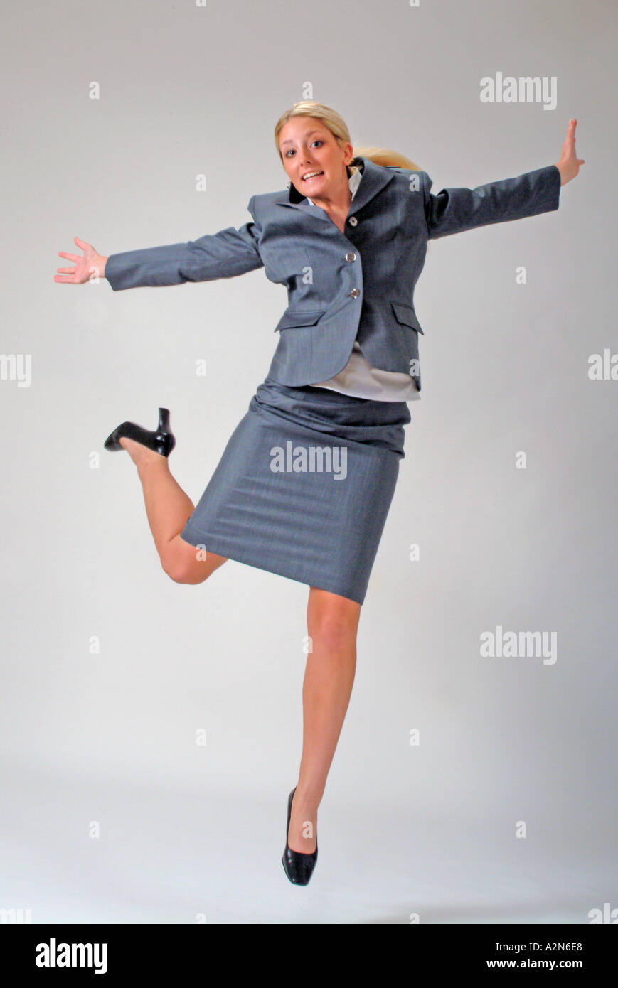 Businesswoman in business suit on white background Stock Photo - Alamy