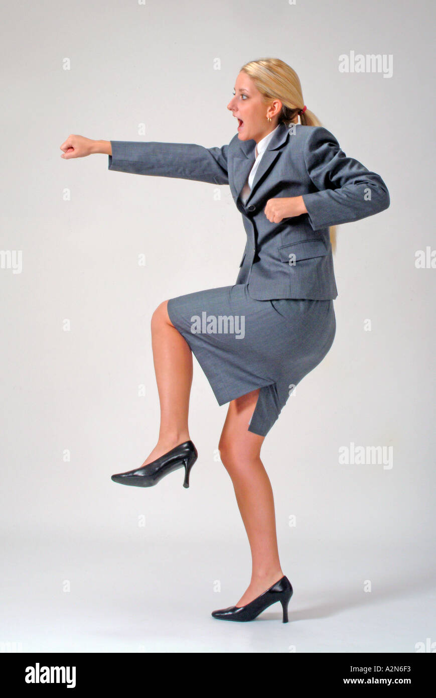 Businesswoman in business suit standing on white background Stock Photo ...