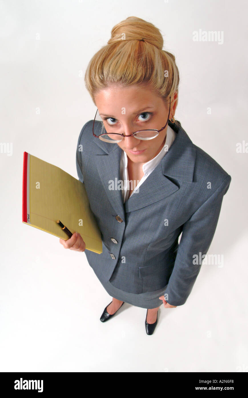 Businesswoman in business suit standing on white background looking up Stock Photo