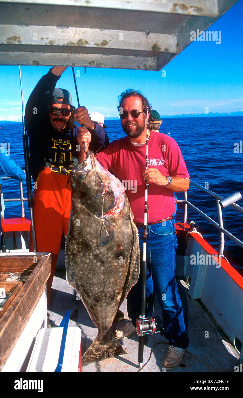 Tourist with Pacific Halibut about 80 pounds caught off Alaska USA Stock Photo