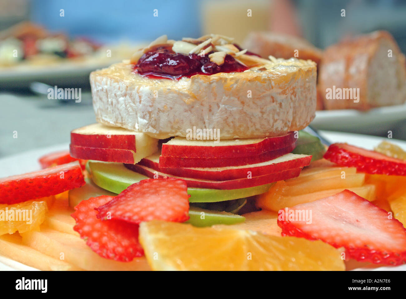 brie cheese and fruit on plate Stock Photo