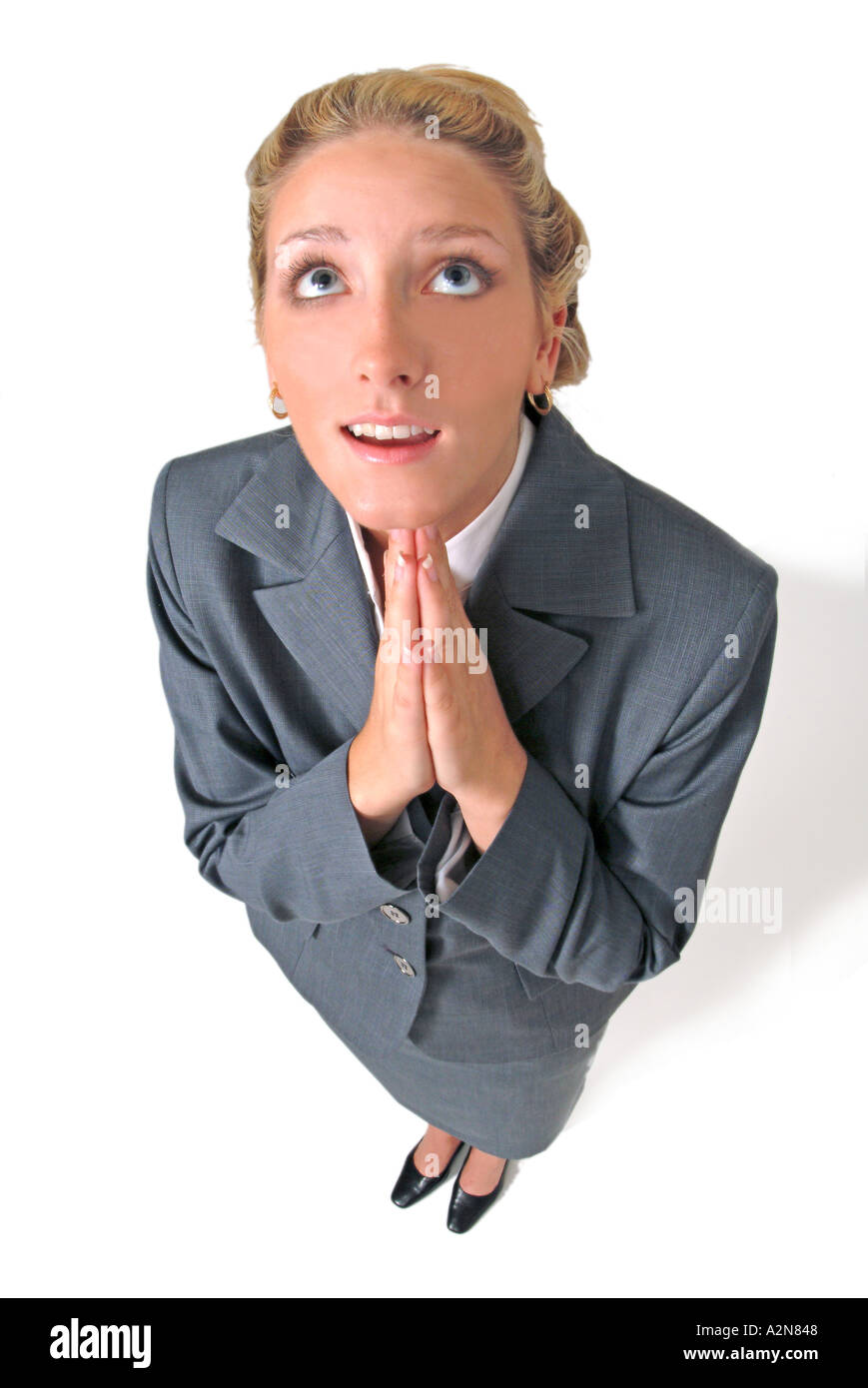 Businesswoman in business suit standing on white background looking up ...