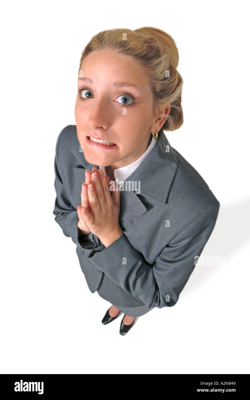 Businesswoman in business suit standing on white background looking up ...