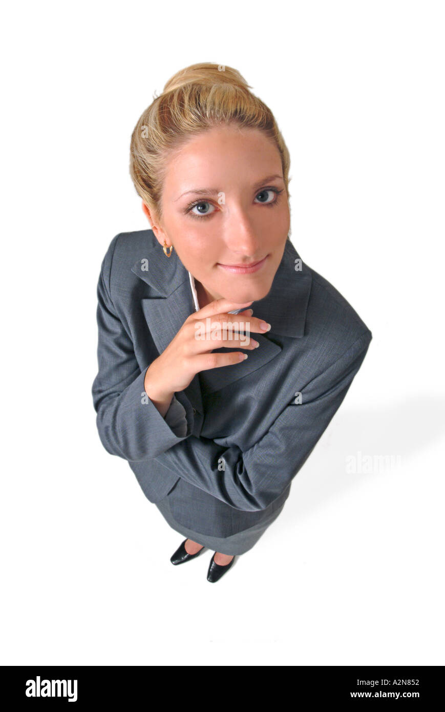 Businesswoman in business suit standing on white background looking up ...