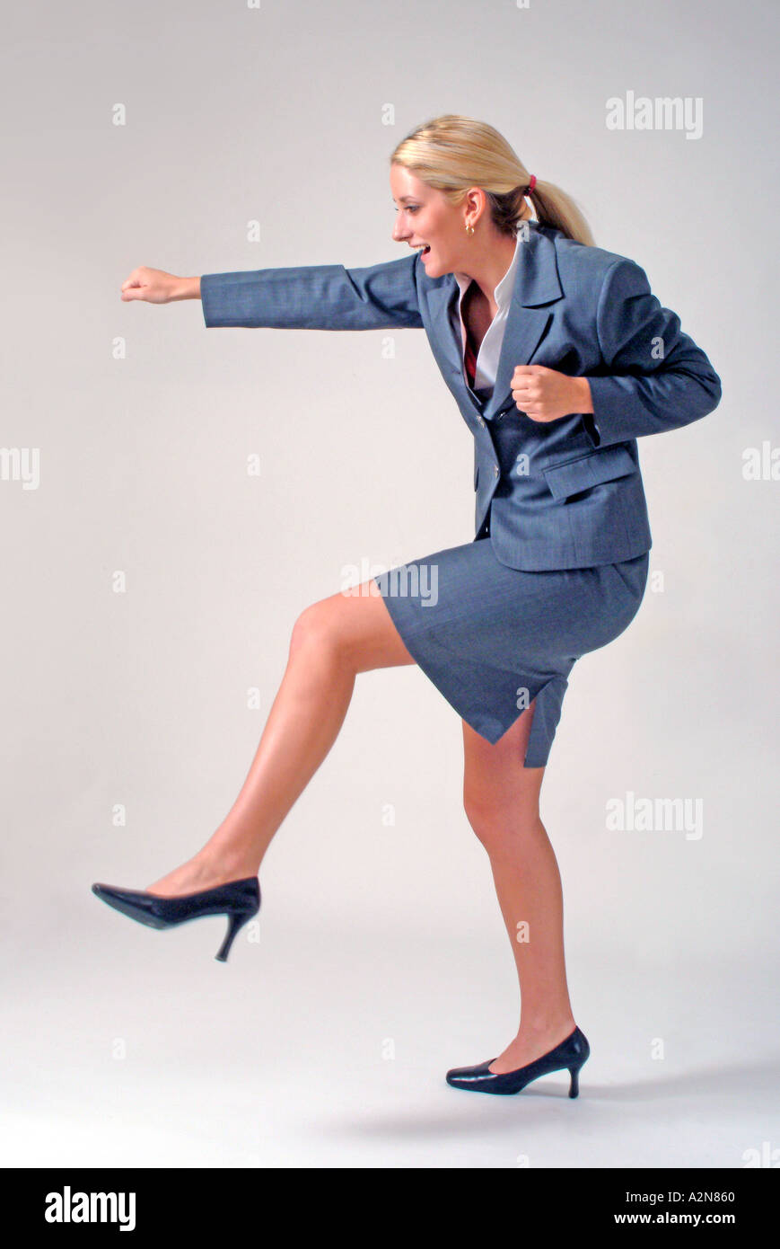 Businesswoman in business suit standing on white background Stock Photo ...