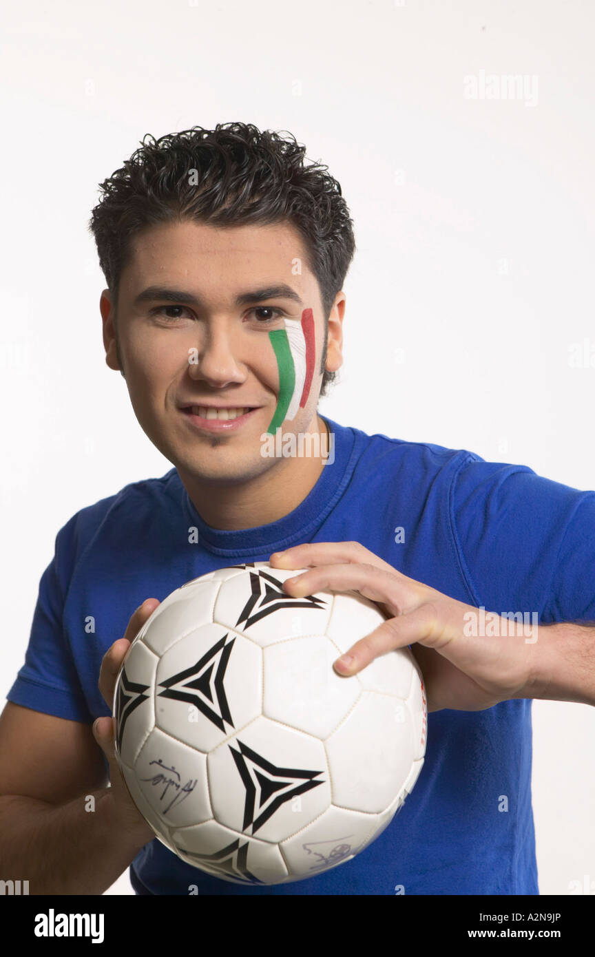 Portrait of young man holding soccer ball and smiling Stock Photo - Alamy