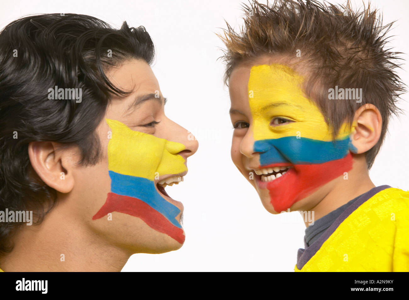 Close-up of two soccer fans with Ecuador painted flag on their faces Stock Photo