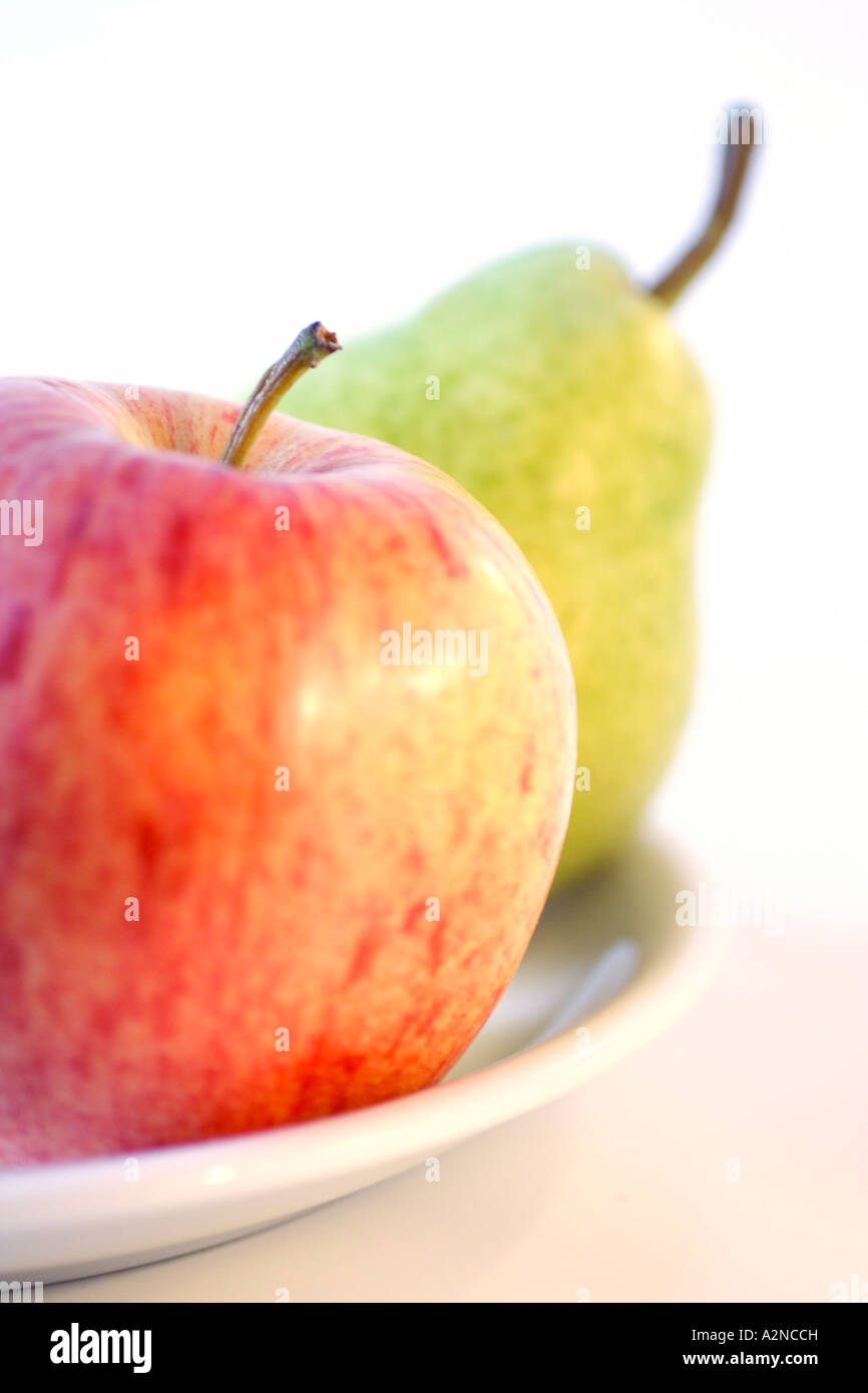 Close-up of apple and pear on plate Stock Photo