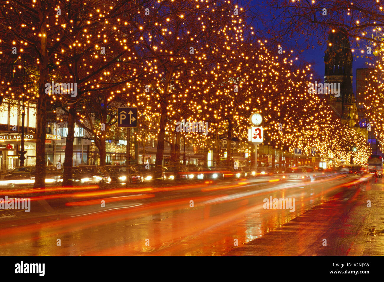 Trees lit up with Christmas lights along road at night Berlin Germany