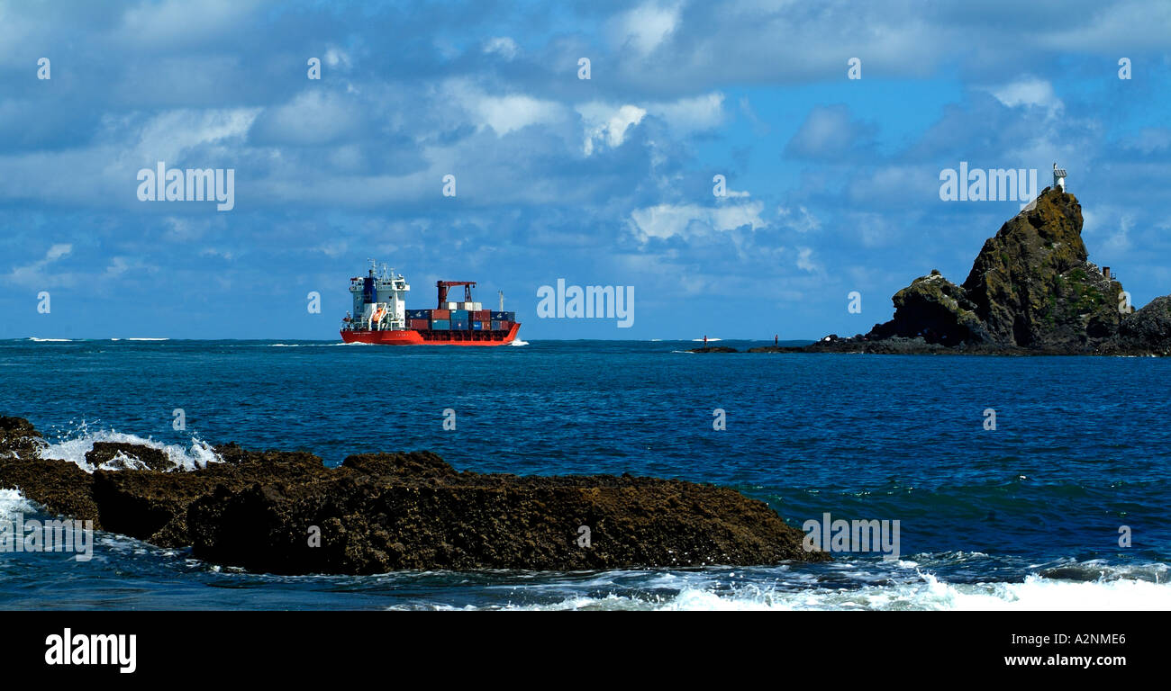 Container ship going out to sea across the bar Manukau Heads North