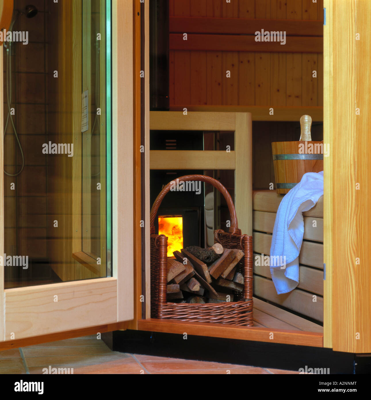 Firewood basket in front of fireplace Stock Photo Alamy