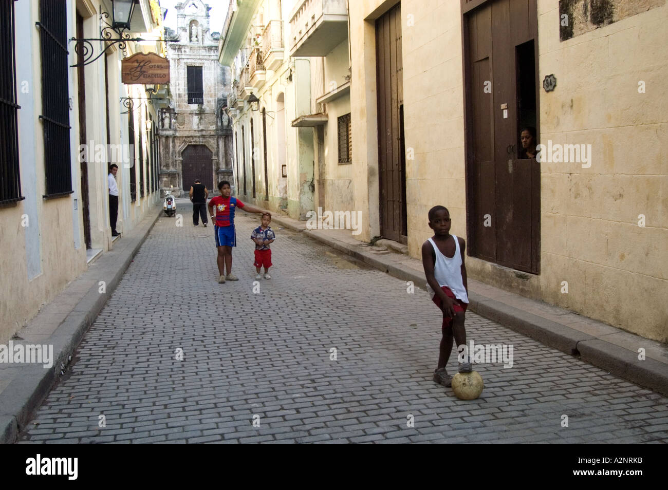 Children playing game of football in the street, Havana, Cuba Stock Photo