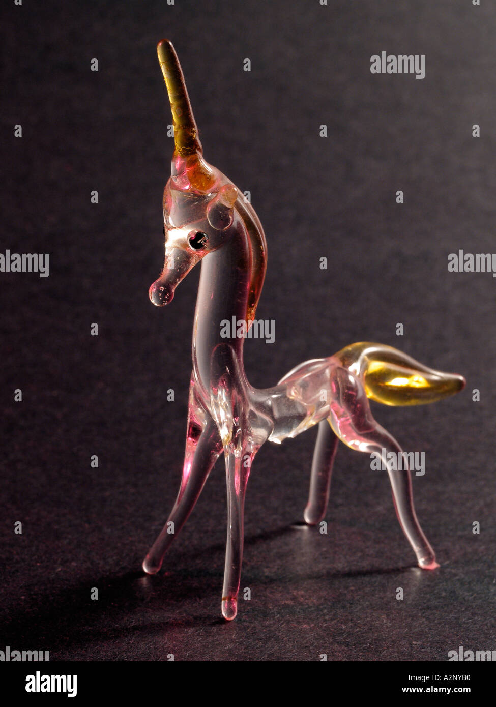 Glass figurine of Unicorn with colored light Stock Photo Alamy