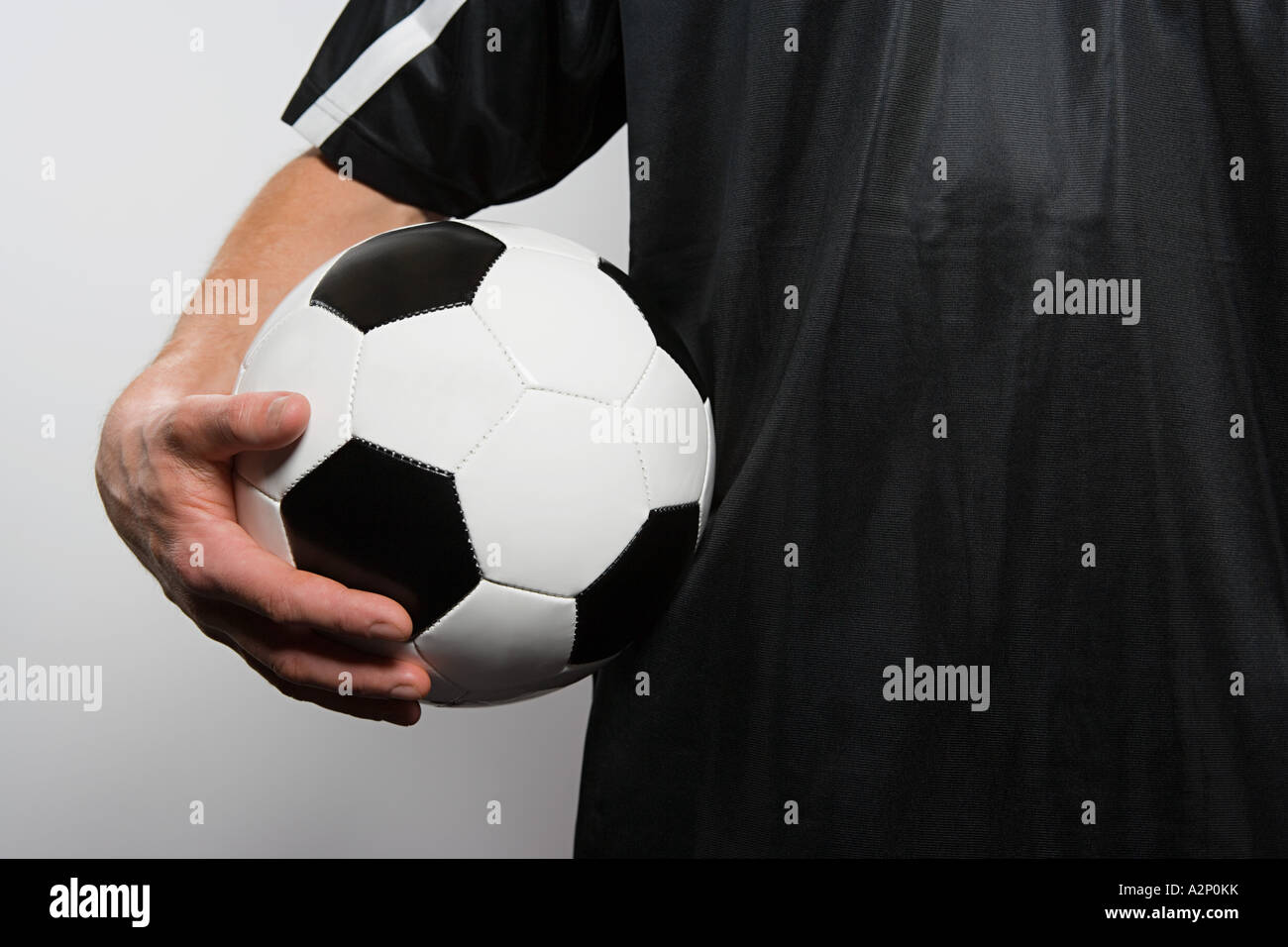Footballer holding football Stock Photo Alamy
