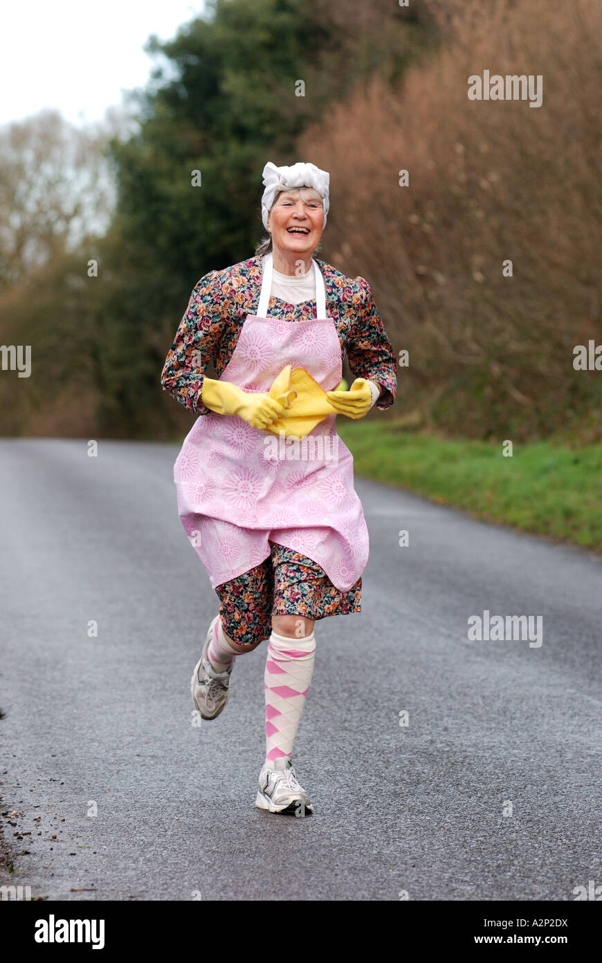 Woman running in fancy dress as Mrs. Mop Stock Photo Alamy