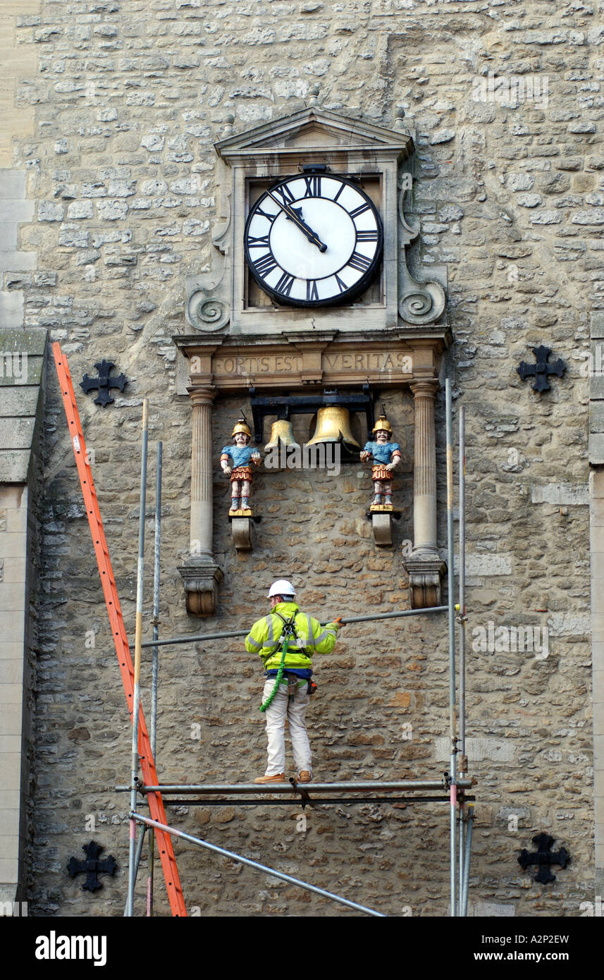 Quarterboys Clock on Carfax Tower with workman erecting scaffolding, Oxford, Oxfordshire, England, UK Stock Photo