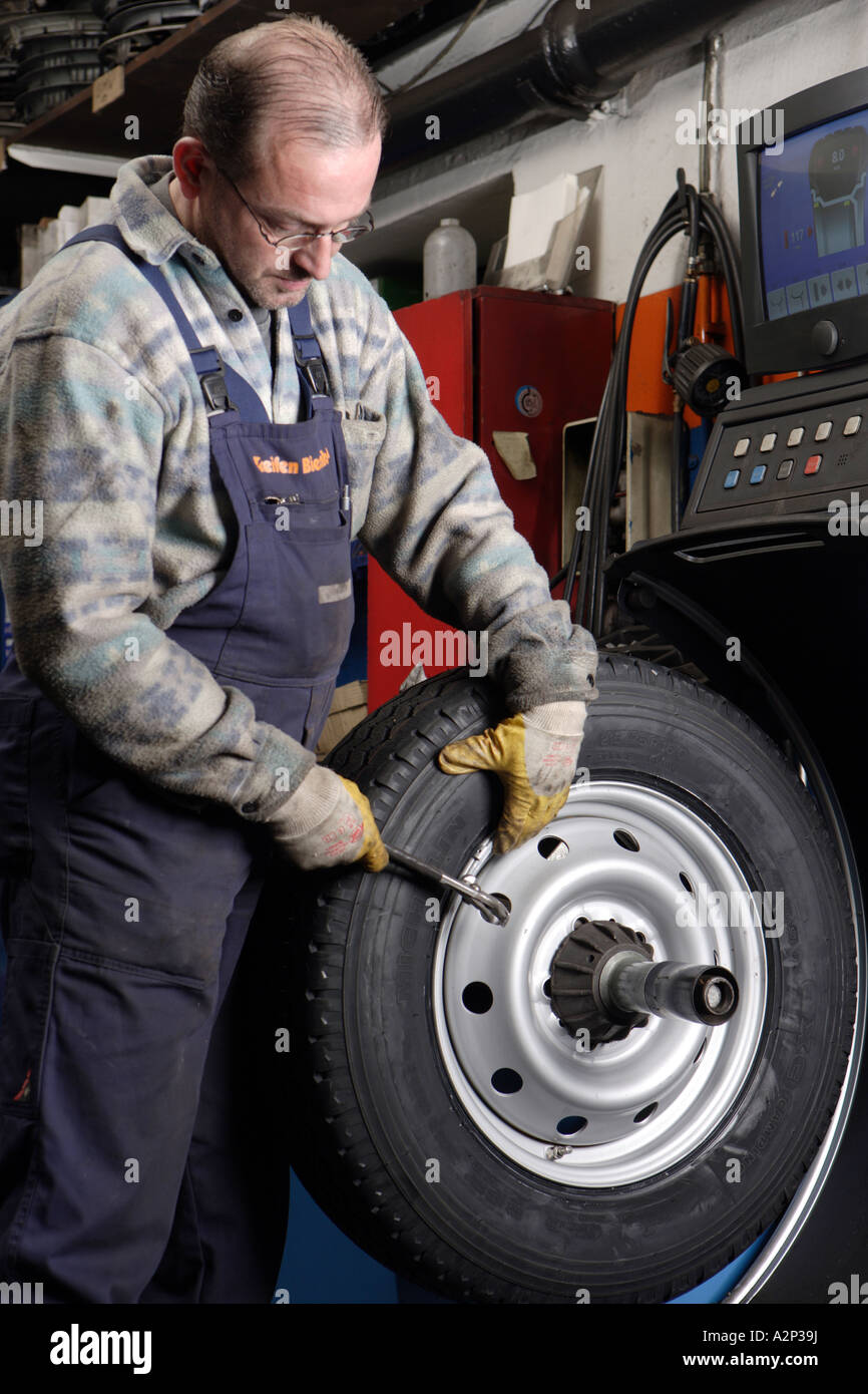 The Mechanic Frank Michels balances the tyres in the motor vehicle workshop Stock Photo