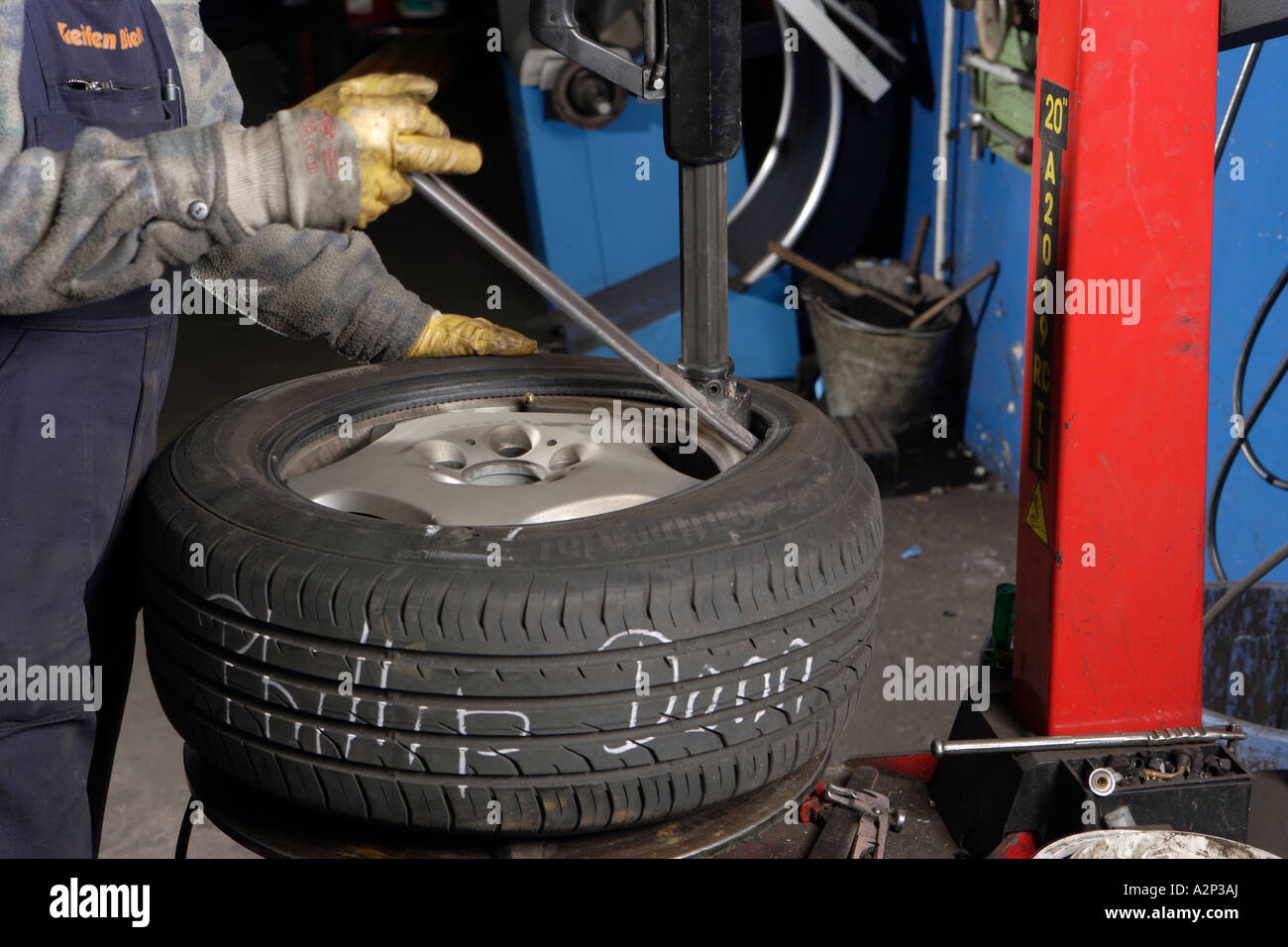 The Mechanic Frank Michels fits new car tyres in the motor vehicle workshop Stock Photo