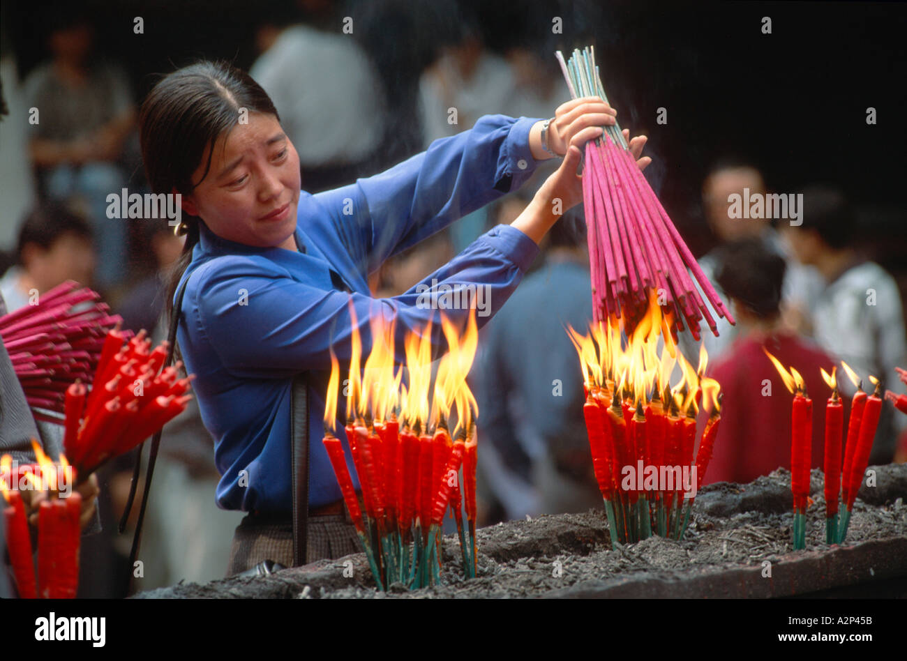 Making offerings with incense sticks at the Grand Buddha Temple, near ...