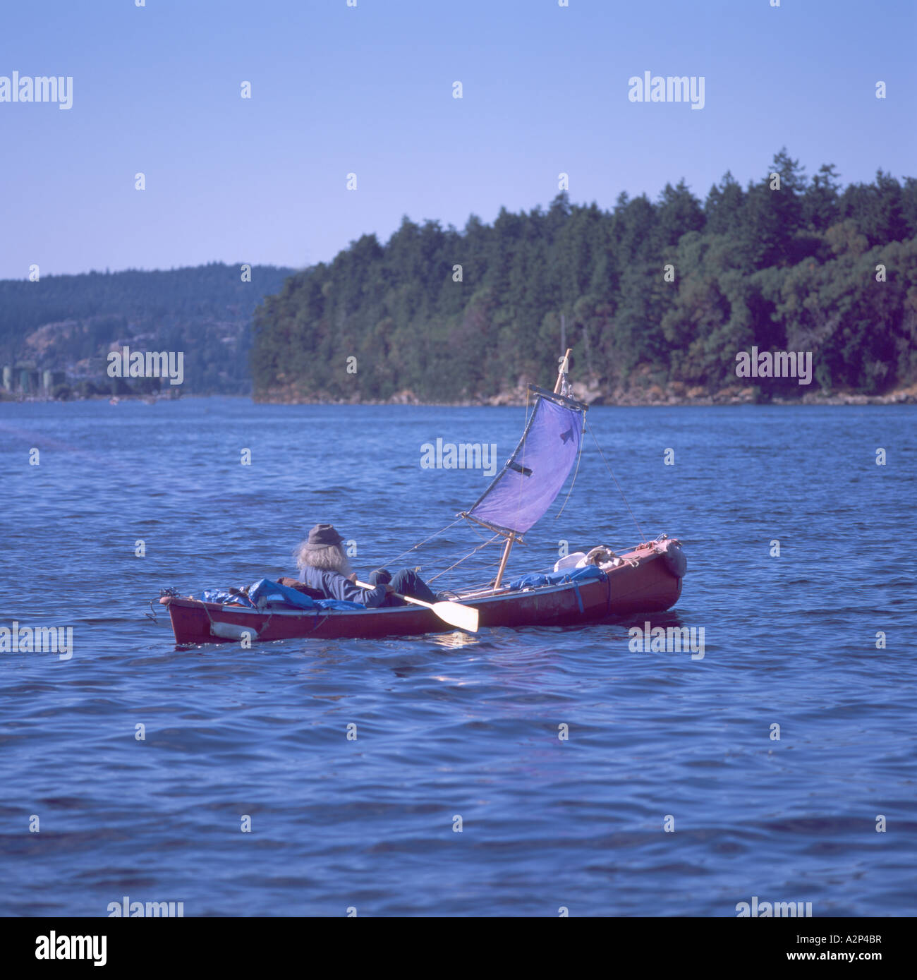 Nanaimo BC Harbour, Vancouver Island, British Columbia, Canada, Sailor Paddler sailing and canoeing Homemade Sailboat Canoe Boat Stock Photo