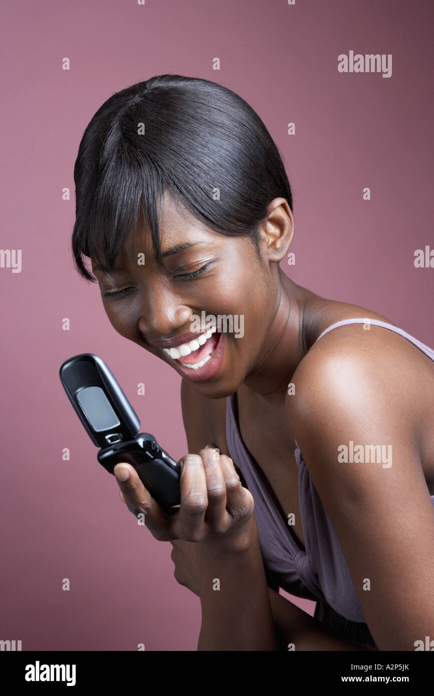 African woman laughing text message hi-res stock photography and images ...