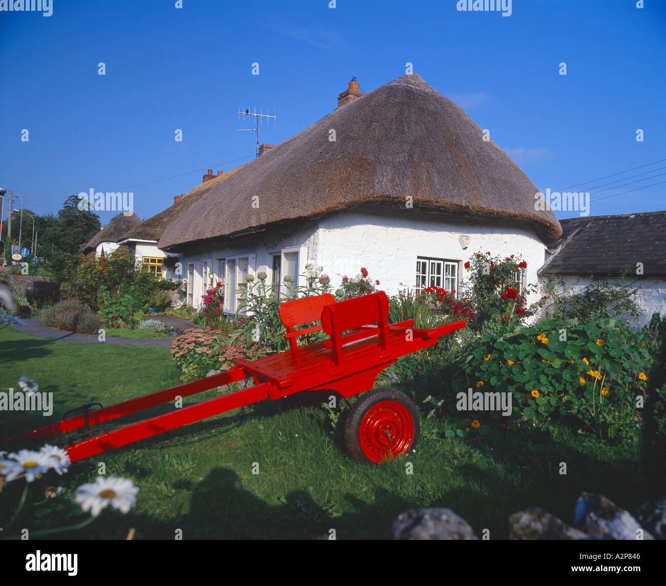 adare village, county limerick ireland, old farm yard cart adorns the