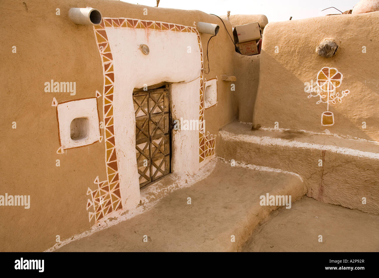 India Rajasthan Thar Desert village architecture decorated mud rendered house doorway Stock Photo