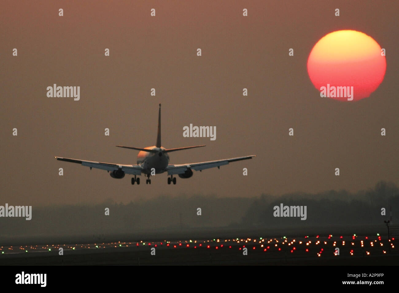 passenger airplane landing on airport Munich at sunset, Germany