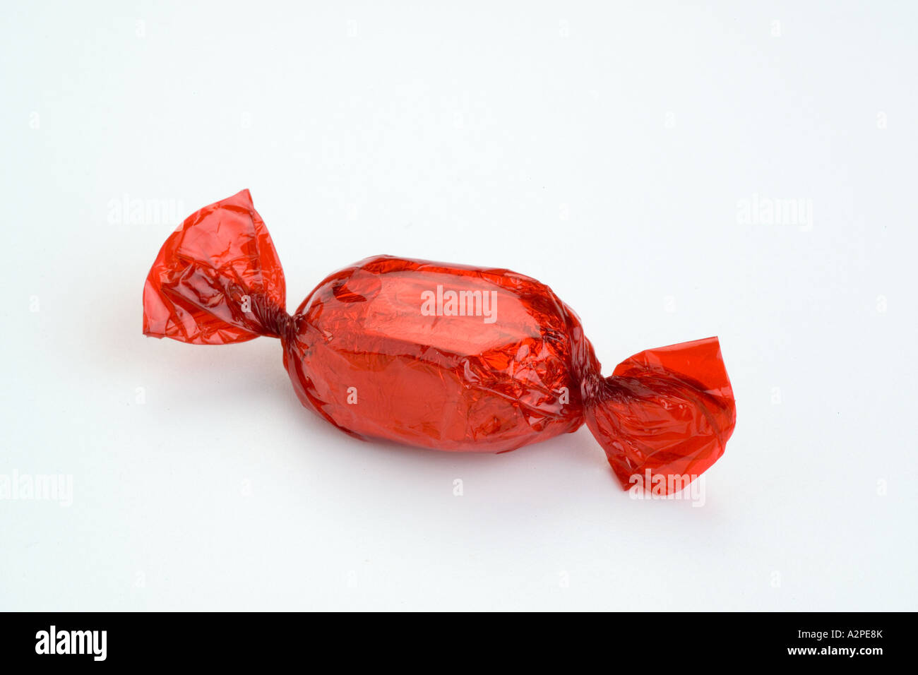 Red toffee cellophane wrapped chocolate sweet Stock Photo Alamy