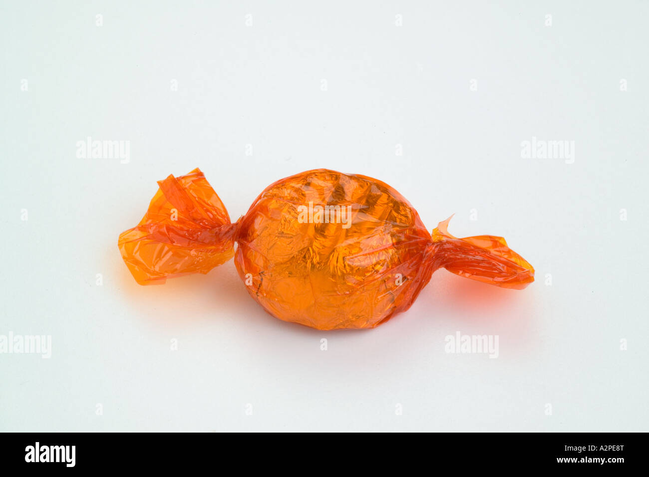 Orange round cellophane wrapped chocolate sweet Stock Photo Alamy