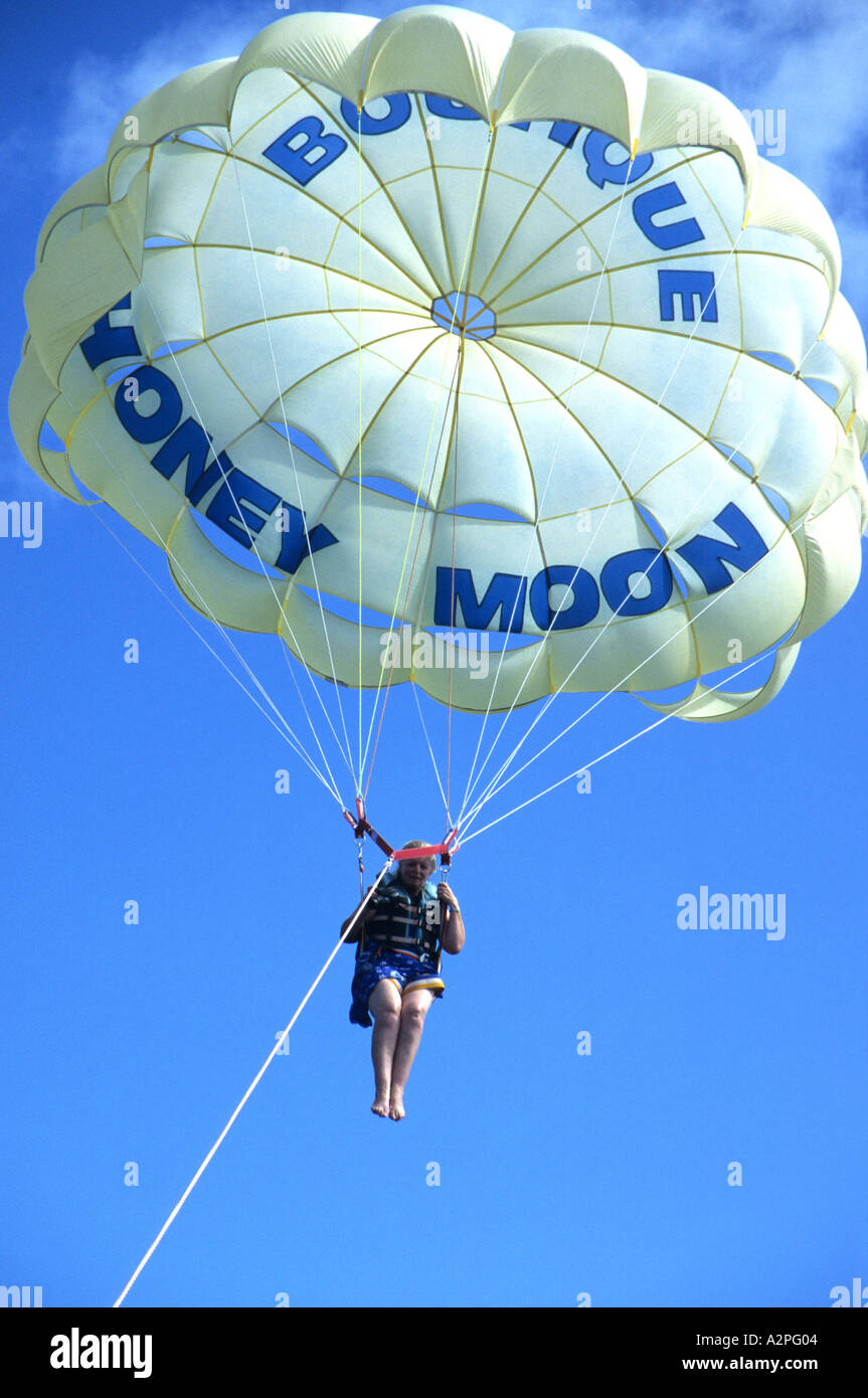 Woman with a parachute being pulled by a speed boat at a holiday resort