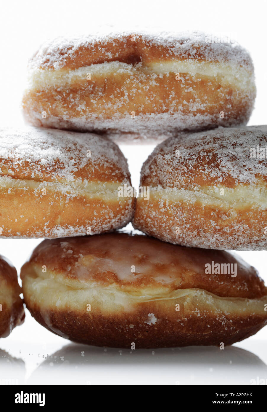 Stacked doughnuts on white background, high key lighting Stock Photo