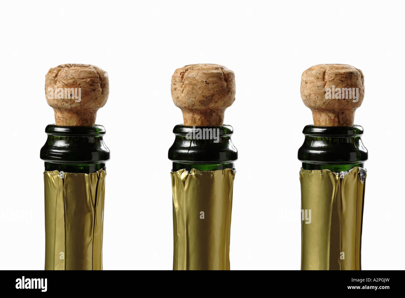 Champagne bottles with corks, side by side, top section, white