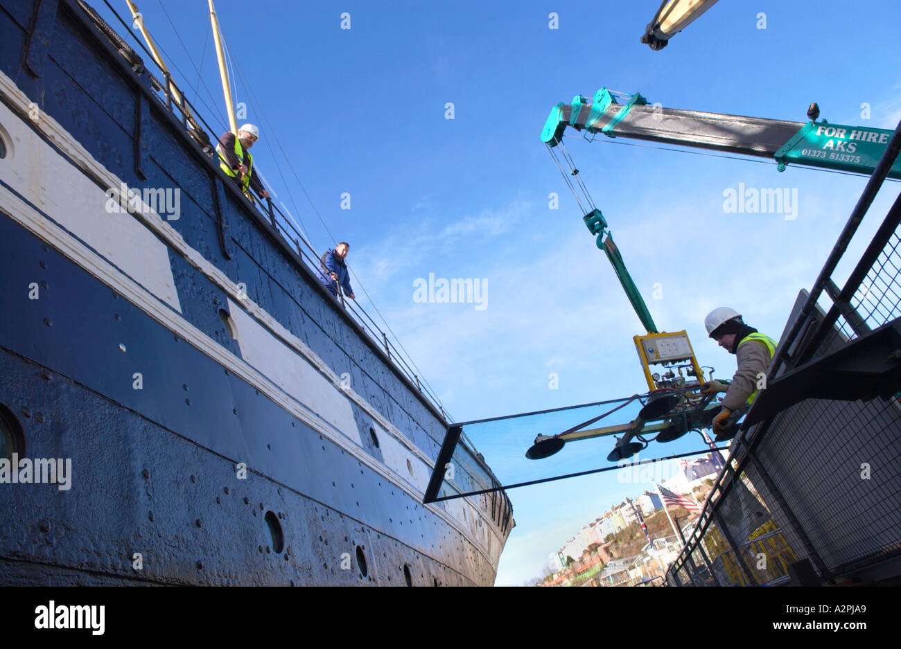 Engineers fit glass panels around the hull of the SS Great Britain ...