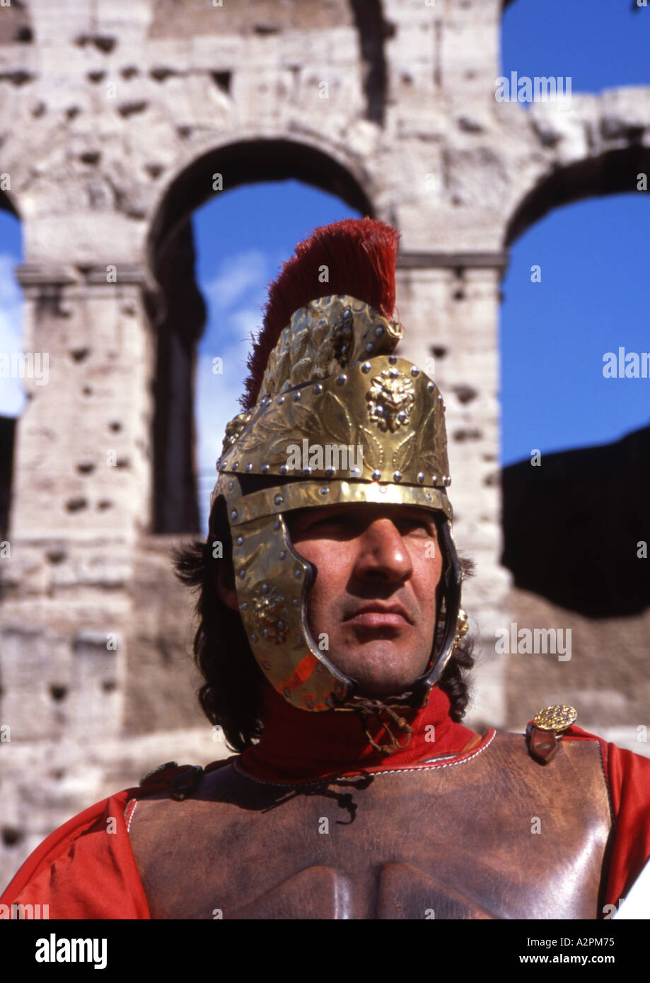Man dressed as a Roman soldier stands outside colosseum in Rome Stock