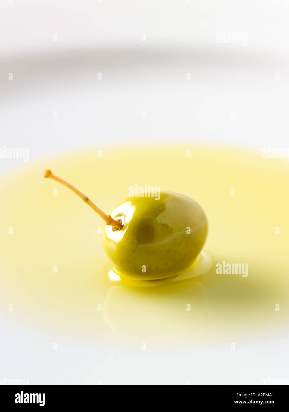 green olive in pool of extra virgin olive oil Stock Photo - Alamy